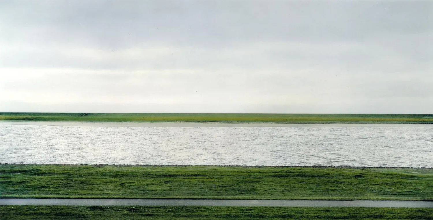 Rhein II by Andreas Gursky — a flat green riverbank under grey sky